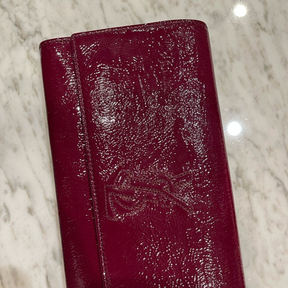 EUC YSL magenta patent leather clutch.